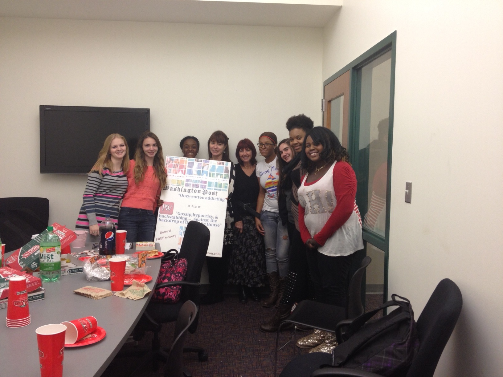 The authors pose with students following a book club meeting.