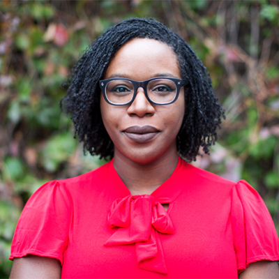 Headshot of author Lesley Nneka Arimah, a Black woman wearing glasses and a red top