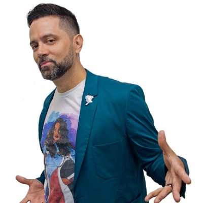 Headshot of author Edgardo Miranda-Rodriguez, a Latin man wearing a graphic t-shirt and a blue blazer