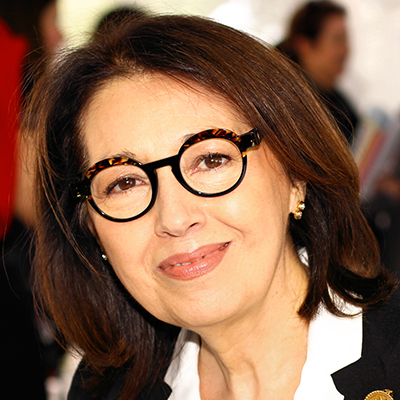 Headshot of Marie Arana, a smiling Latin woman with short hair and glasses