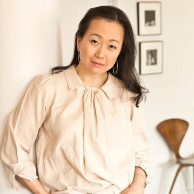 Headshot of author Min Jin Lee, an Asian woman wearing a light-colored blouse