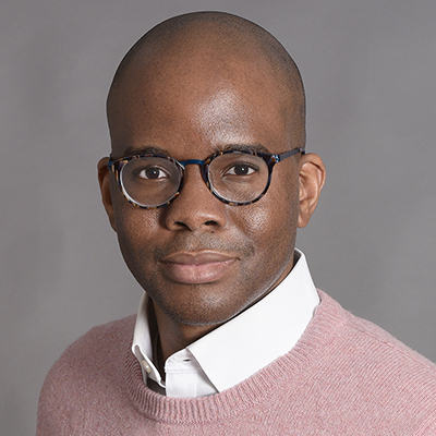 Headshot of Tope Folarin, a Black man wearing glasses and a light pink sweater