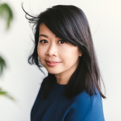 Headshot of a Southeast Asian woman with dark hair wearing a blue top