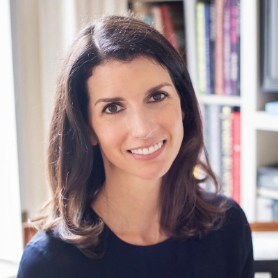 Headshot of smiling White woman, Katherine Boone, with shoulder-length brown hair wearing a dark top