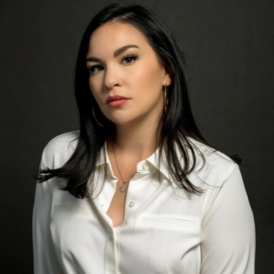 Headshot of author Kali Fajardo-Anstine, a person with long black hair wearing a white collared shirt