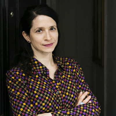 Headshot of author Chloe Aridjis, a Latin woman wearing a colorful patterned top