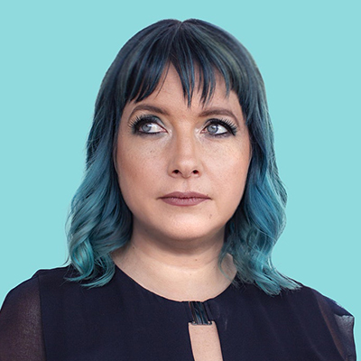 Headshot of author Lauren Beukes, a White woman with blue hair wearing a black top against a teal background