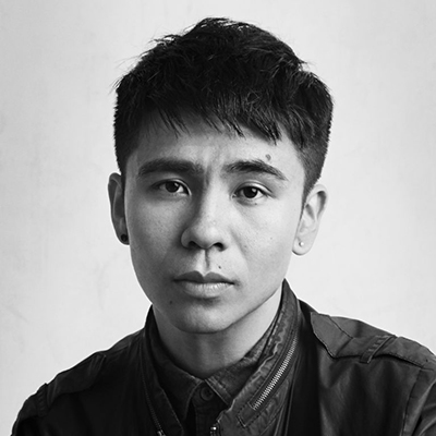 Black and white headshot of author Ocean Vuong, an Asian man wearing a dark jacket