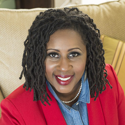 Headshot of Ramunda Young, a smiling Black woman wearing a red blazer