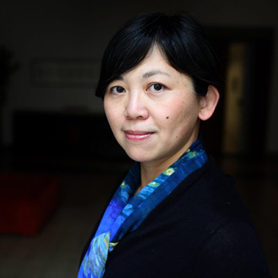 Headshot of author Yiyun Li, an Asian woman with short hair and a colorful scarf