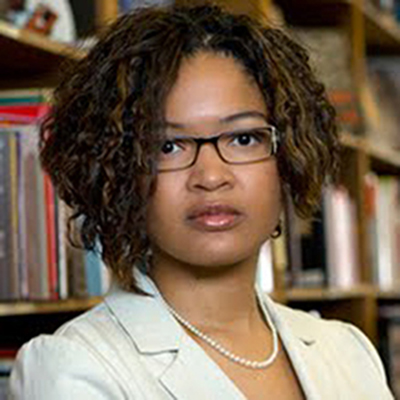 Headshot of Dolen Perkins-Valdez, a Black woman wearing glasses and a white blazer