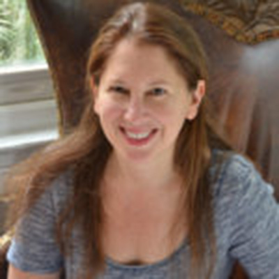 Headshot of Susan Coll, a White woman with long hair and a gray top